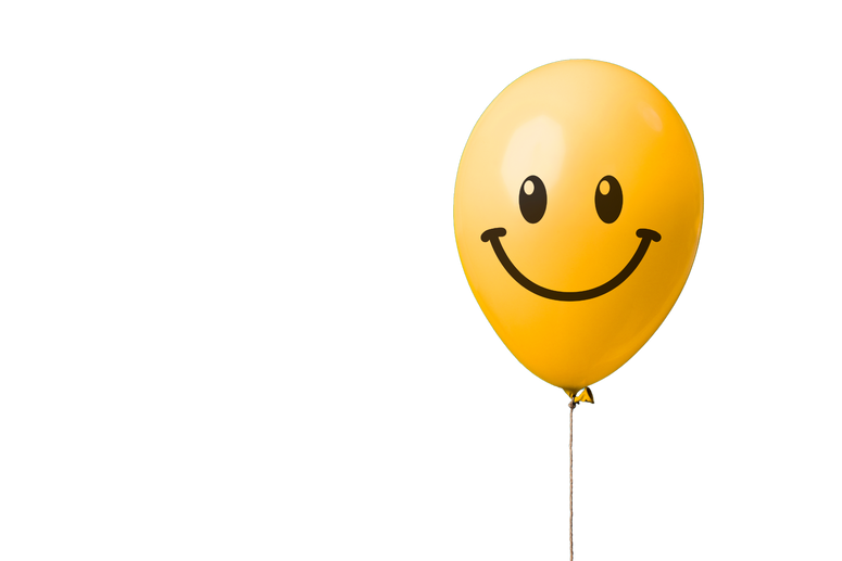 Yellow Balloon with Happy Face on a Blue Background